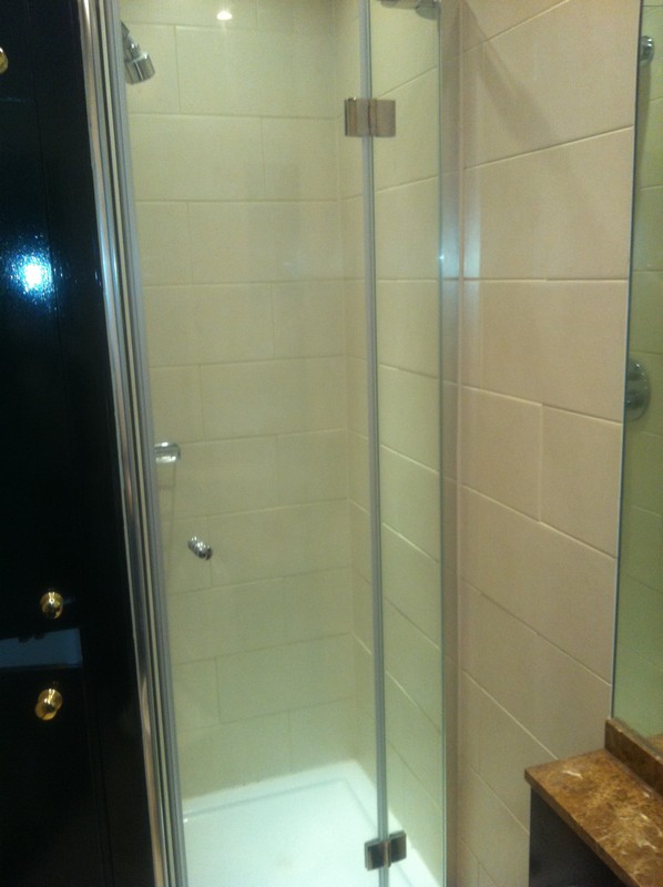 Frameless glass shower enclosure with chrome fittings in Tulse Hill