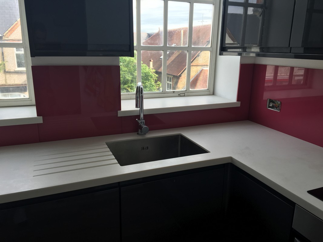 Deep plum coloured glass splashback in modern Tulse Hill kitchen